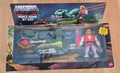 Masters of the Universe Prince Adam Sky Sled action figure in its original window box packaging, displayed on a light wood surface. The package includes the toy figure, the teal and yellow sky sled, and the illustrated header card.